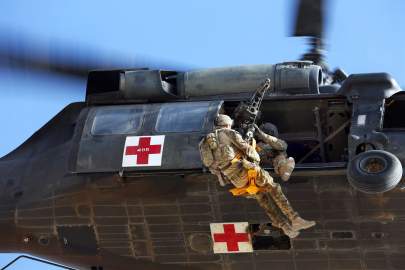 A U.S. Army UH_60 Black Hawk helicopter hoists an Australian airman on a jungle penetrator during medevac training on Multinational Base Tarin Kot in Afghanistan_s U